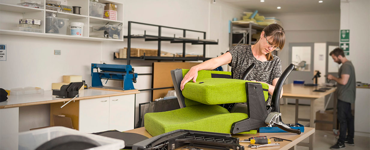 industrial designer working on prototype to show client a theatre seat mechanism